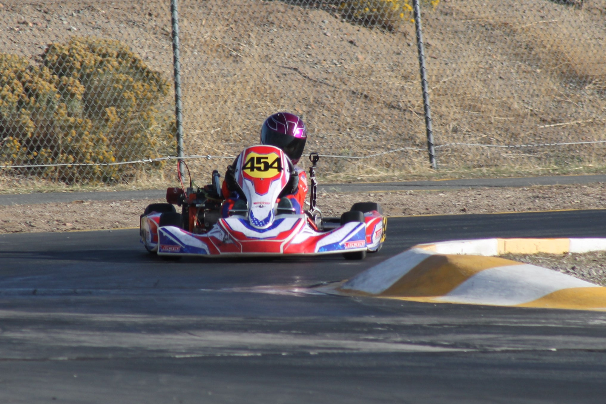 Kart driver racing towards left turn
